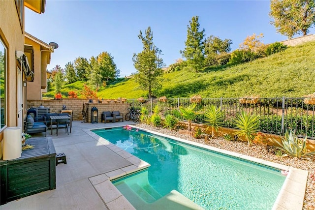 view of pool with a patio area, a fenced backyard, and a fenced in pool