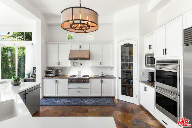 kitchen featuring hanging light fixtures, tasteful backsplash, a notable chandelier, white cabinets, and appliances with stainless steel finishes