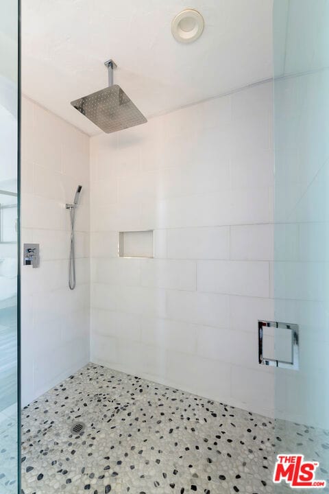 bathroom featuring a shower with door