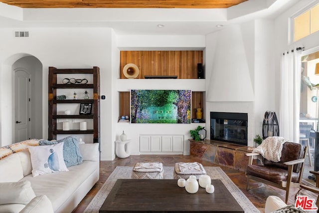 living room with a fireplace and a wealth of natural light