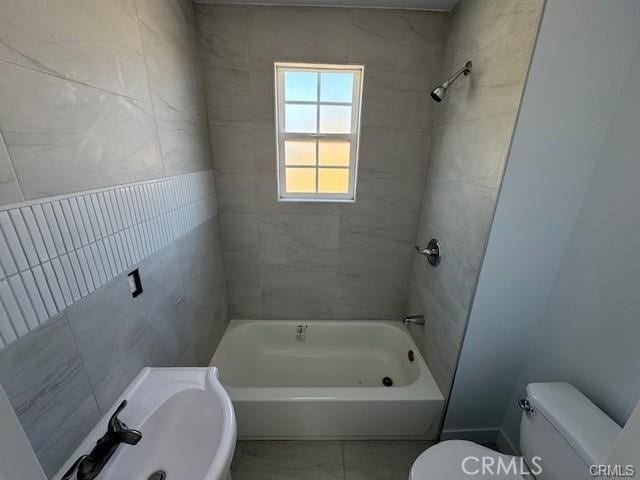 full bathroom with sink, toilet, and tiled shower / bath