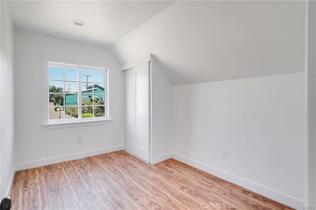 bonus room featuring light hardwood / wood-style floors and vaulted ceiling