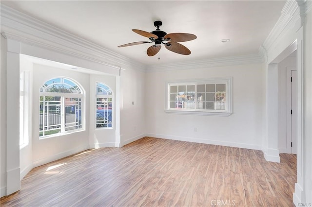 empty room with light hardwood / wood-style floors, ceiling fan, and ornamental molding