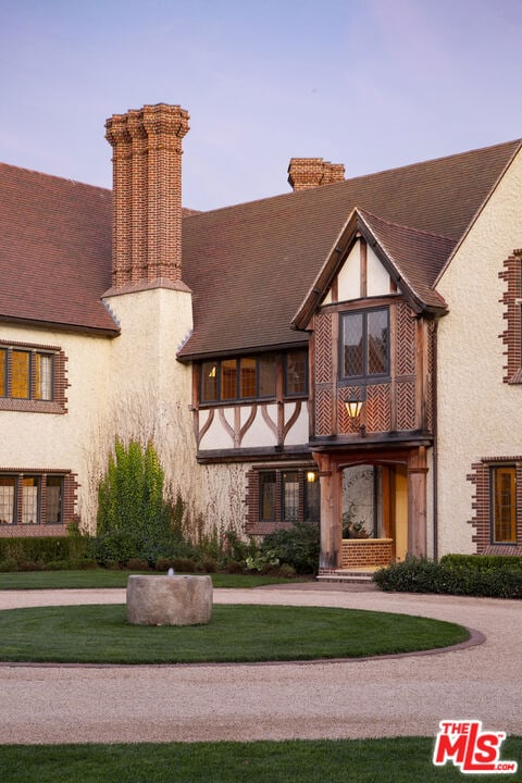 tudor home featuring a lawn