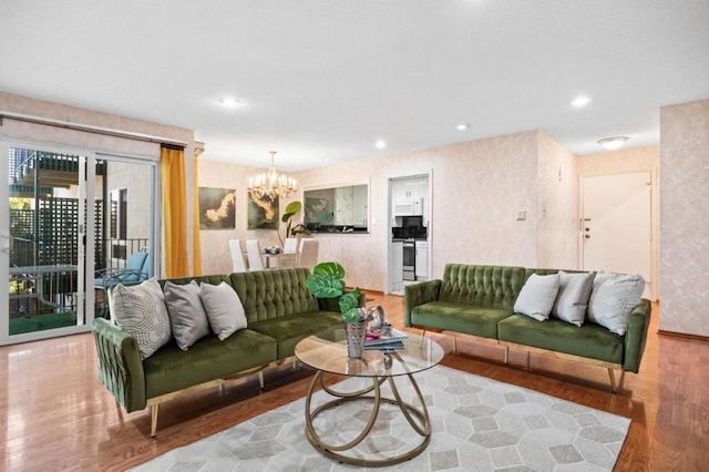 living room with an inviting chandelier and light hardwood / wood-style floors