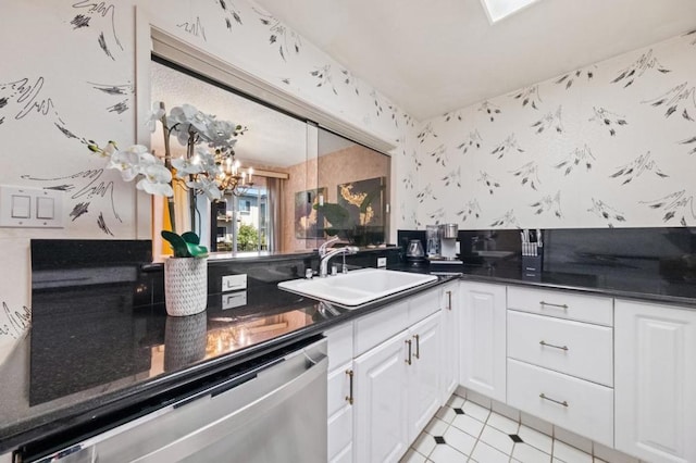 kitchen featuring sink, white cabinetry, an inviting chandelier, light tile patterned floors, and dishwasher