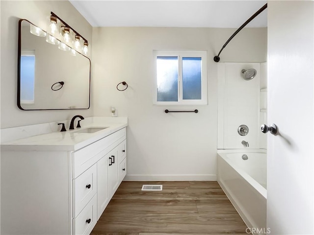 bathroom with shower / bathing tub combination, vanity, and wood-type flooring