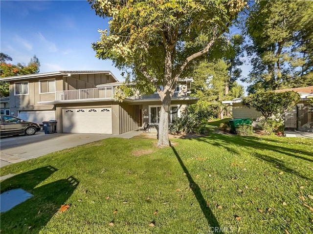 view of front of property with a balcony, a garage, and a front yard