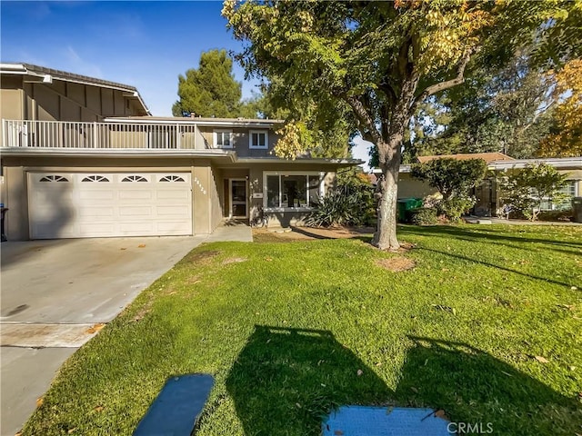 front facade with a garage, a front lawn, and a balcony