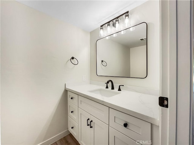 bathroom with vanity and hardwood / wood-style flooring