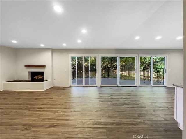 unfurnished living room with wood-type flooring