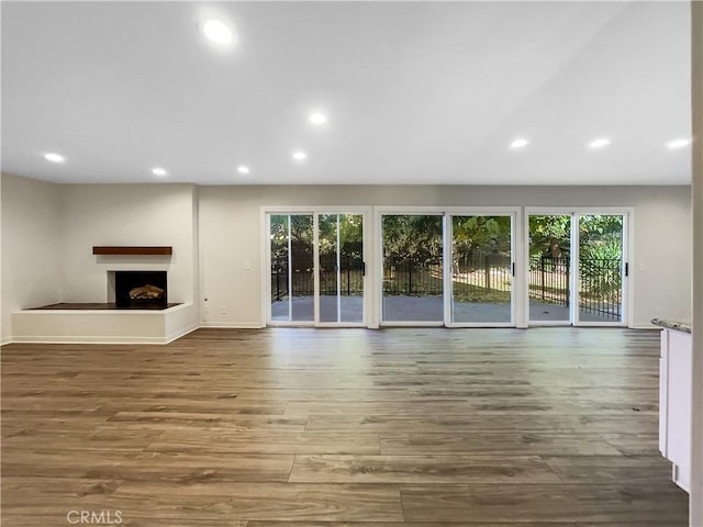 unfurnished living room with hardwood / wood-style flooring