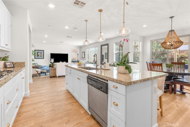 kitchen with appliances with stainless steel finishes, light hardwood / wood-style flooring, and a healthy amount of sunlight