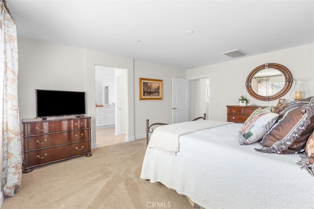 carpeted bedroom featuring ensuite bathroom