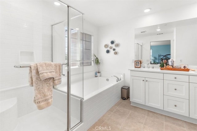 bathroom featuring vanity, tile patterned floors, and independent shower and bath