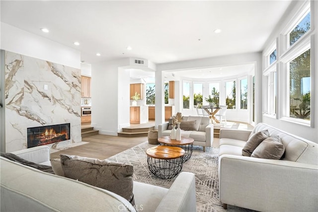 living room featuring light hardwood / wood-style floors and a fireplace