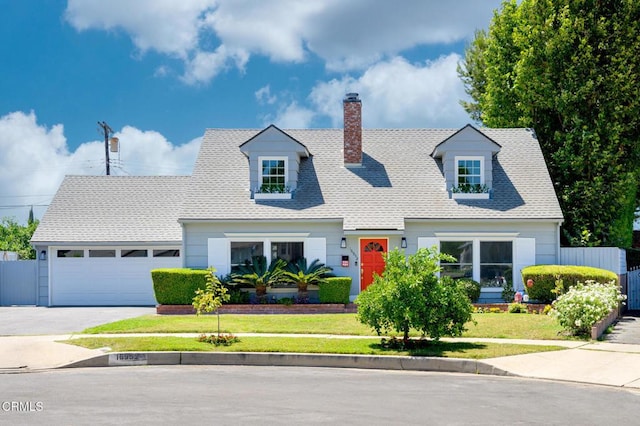 cape cod home featuring a front yard and a garage