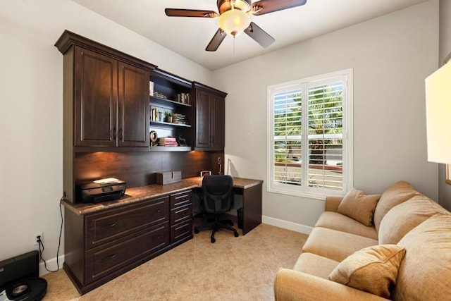 office area featuring ceiling fan and built in desk