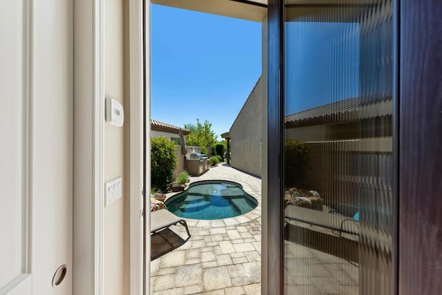 view of pool with a jacuzzi