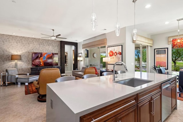 kitchen featuring a center island with sink, dishwasher, pendant lighting, and sink