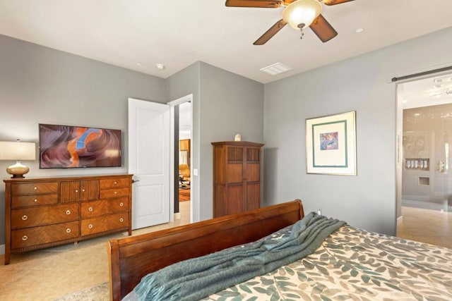 tiled bedroom with ensuite bathroom and ceiling fan