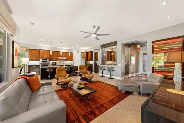 living room featuring a wealth of natural light and ceiling fan