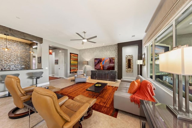 tiled living room with ceiling fan