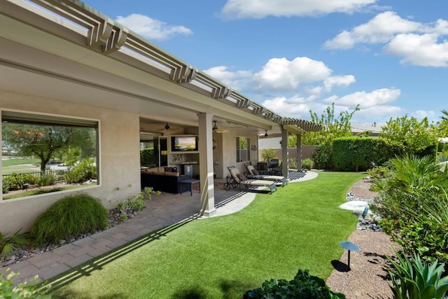 view of yard with a pergola, outdoor lounge area, ceiling fan, and a patio