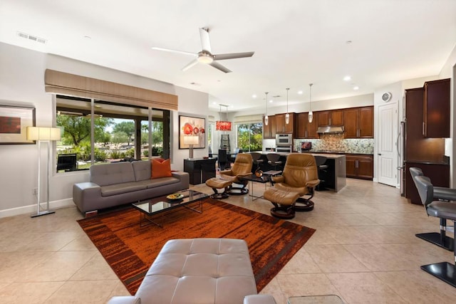 living room with ceiling fan and light tile patterned floors