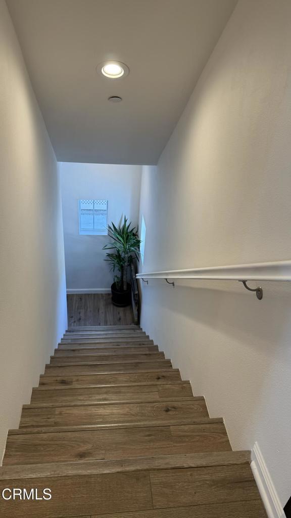 stairway featuring hardwood / wood-style floors