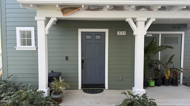 view of exterior entry with covered porch