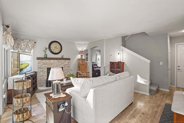 living room featuring a fireplace and light hardwood / wood-style floors