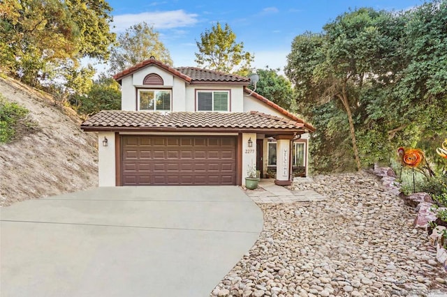 mediterranean / spanish-style house featuring a garage