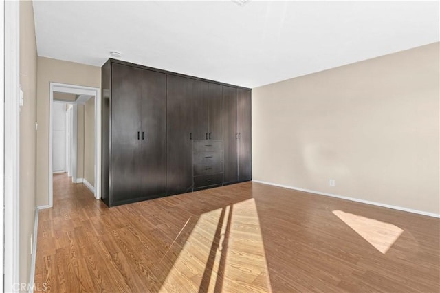 unfurnished bedroom featuring a closet and light hardwood / wood-style floors