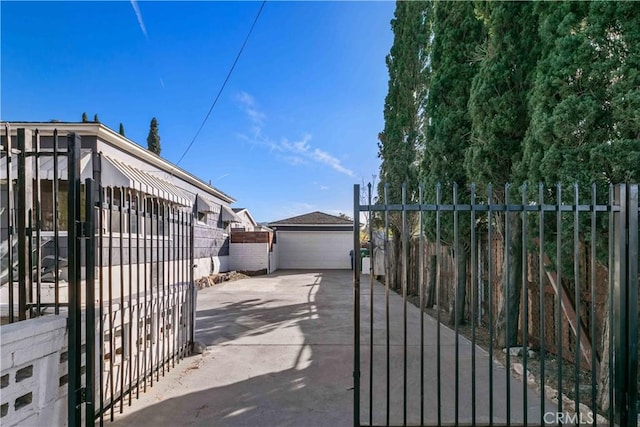 view of gate featuring an outbuilding