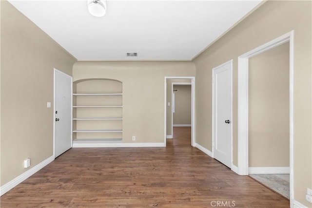 unfurnished bedroom with dark hardwood / wood-style flooring