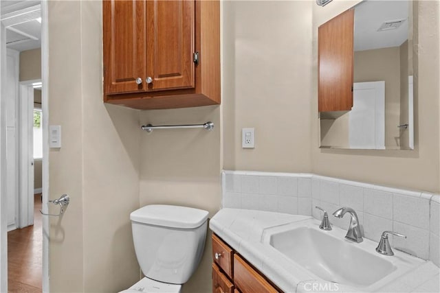 bathroom featuring vanity and toilet