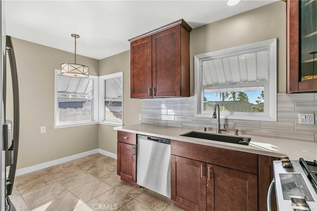 kitchen featuring backsplash, dishwasher, plenty of natural light, and range