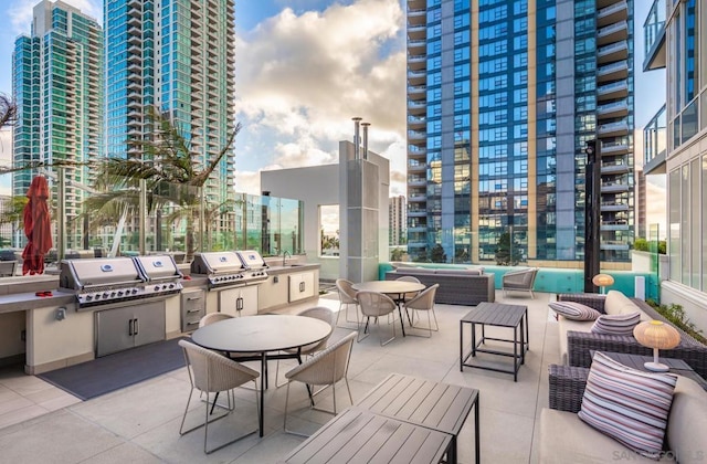 view of patio with an outdoor living space, area for grilling, sink, and a grill