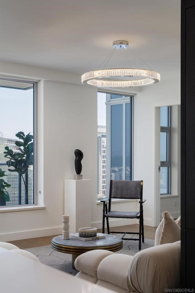 interior space featuring hardwood / wood-style floors, a healthy amount of sunlight, and an inviting chandelier