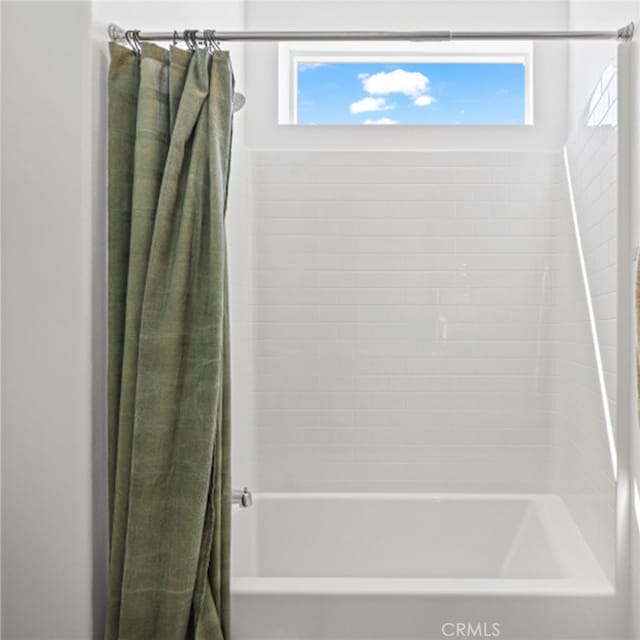 bathroom featuring shower / bathtub combination with curtain