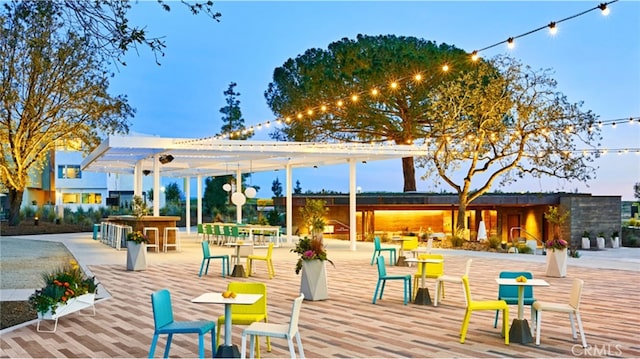 surrounding community featuring a pergola and an outdoor bar