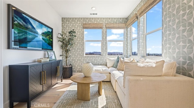 living room with a wealth of natural light and hardwood / wood-style floors