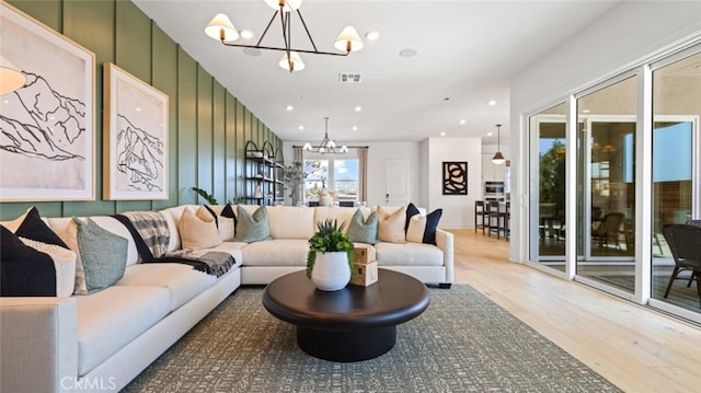 living room with hardwood / wood-style floors and a chandelier