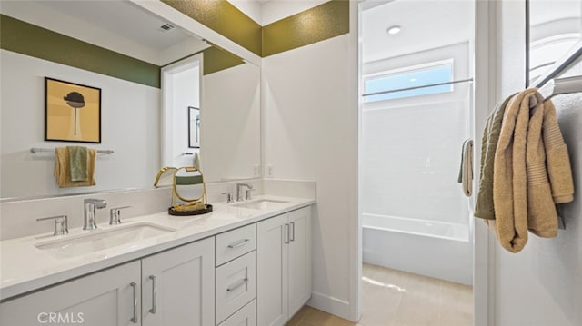 bathroom with tile patterned flooring, vanity, and shower / washtub combination