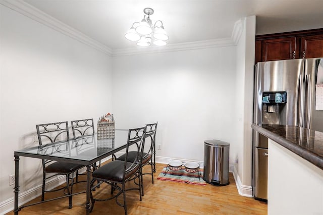 dining area featuring an inviting chandelier, ornamental molding, and light hardwood / wood-style flooring