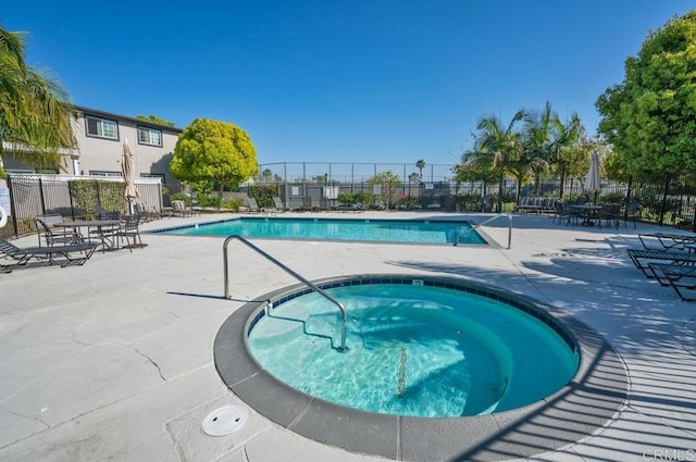 view of swimming pool with a community hot tub and a patio