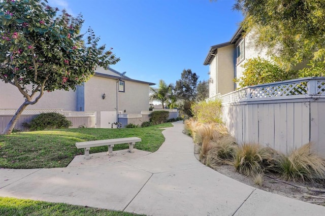 view of side of home with a yard and a patio