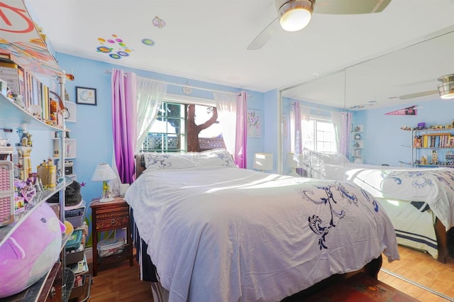 bedroom with ceiling fan and wood-type flooring