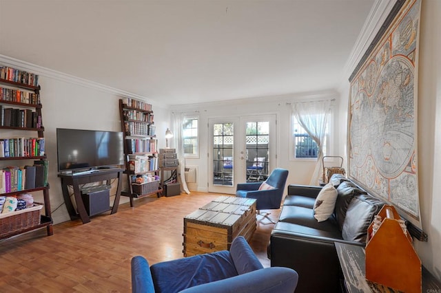 living room featuring ornamental molding, french doors, and light wood-type flooring